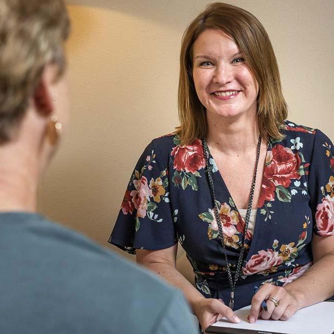 Smiling counselor meeting with female patient